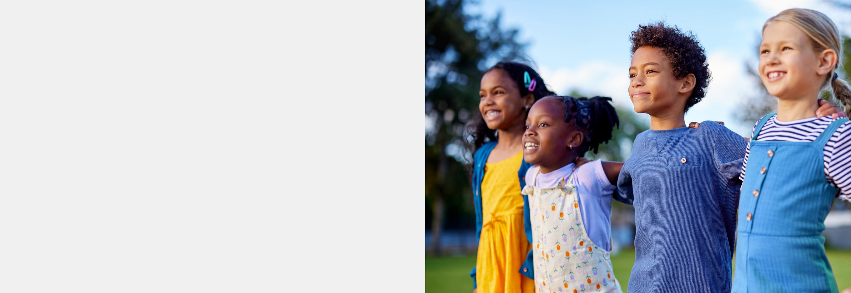 Four kids lined up with arms linked